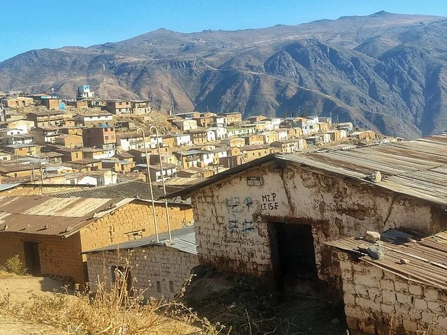 Hillside village with traditional houses in Marcahuasi against a mountain backdrop.